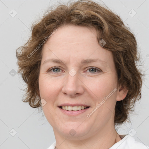 Joyful white adult female with medium  brown hair and green eyes