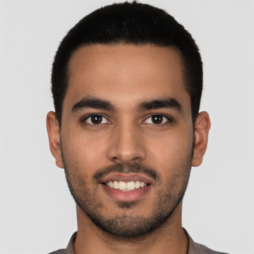 Joyful latino young-adult male with short  black hair and brown eyes