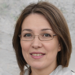 Joyful white adult female with medium  brown hair and blue eyes