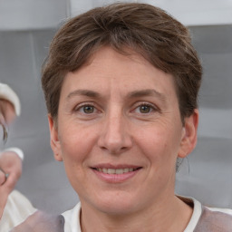 Joyful white adult female with short  brown hair and grey eyes