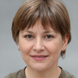 Joyful white adult female with medium  brown hair and grey eyes