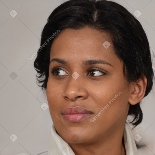 Joyful black young-adult female with medium  brown hair and brown eyes