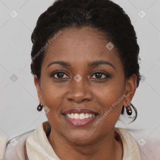 Joyful black young-adult female with short  brown hair and brown eyes