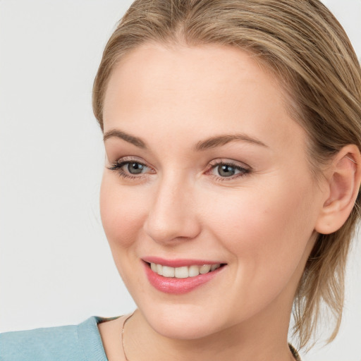 Joyful white young-adult female with medium  brown hair and blue eyes