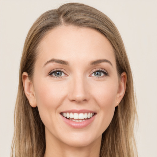 Joyful white young-adult female with long  brown hair and grey eyes