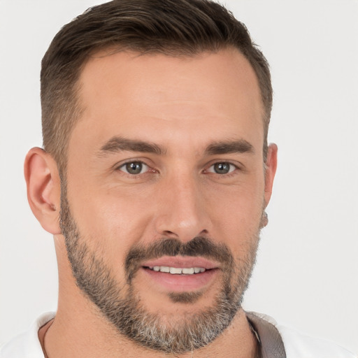 Joyful white young-adult male with short  brown hair and brown eyes