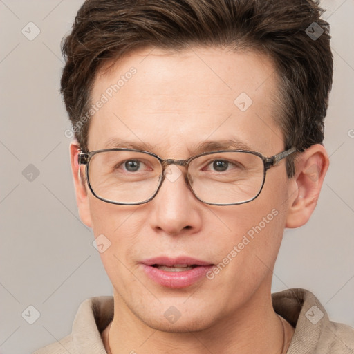 Joyful white adult male with short  brown hair and grey eyes