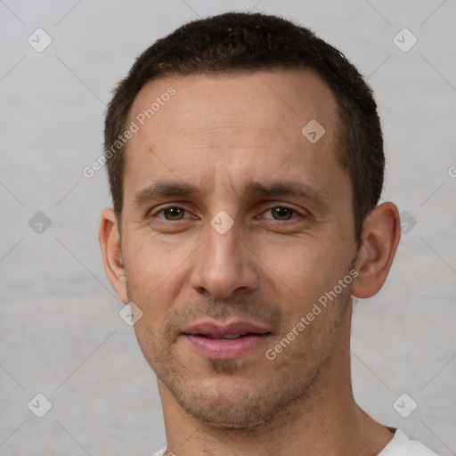 Joyful white adult male with short  brown hair and brown eyes