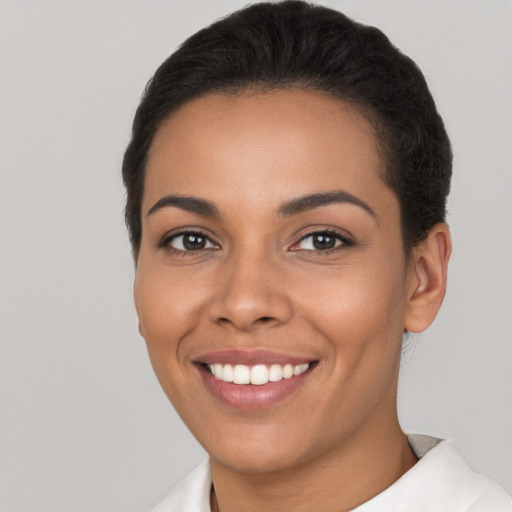 Joyful latino young-adult female with short  brown hair and brown eyes