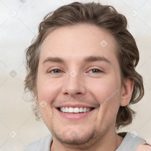 Joyful white young-adult male with medium  brown hair and brown eyes