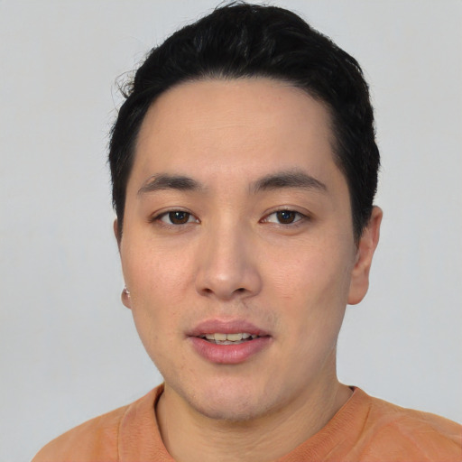 Joyful asian young-adult male with short  black hair and brown eyes