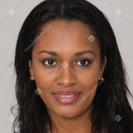 Joyful black young-adult female with long  brown hair and brown eyes