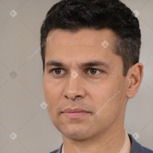 Joyful white young-adult male with short  black hair and brown eyes