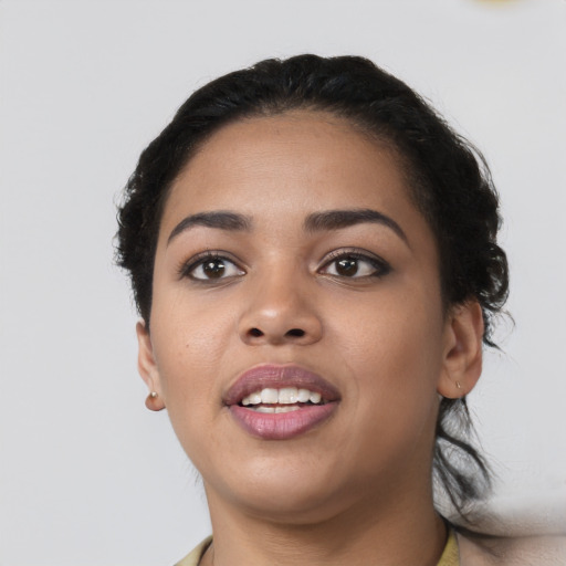 Joyful latino young-adult female with short  black hair and brown eyes