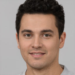 Joyful white young-adult male with short  black hair and brown eyes