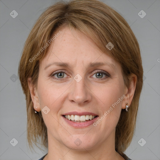 Joyful white adult female with medium  brown hair and grey eyes