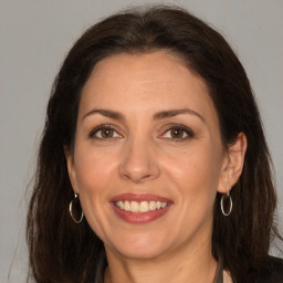 Joyful white adult female with long  brown hair and brown eyes