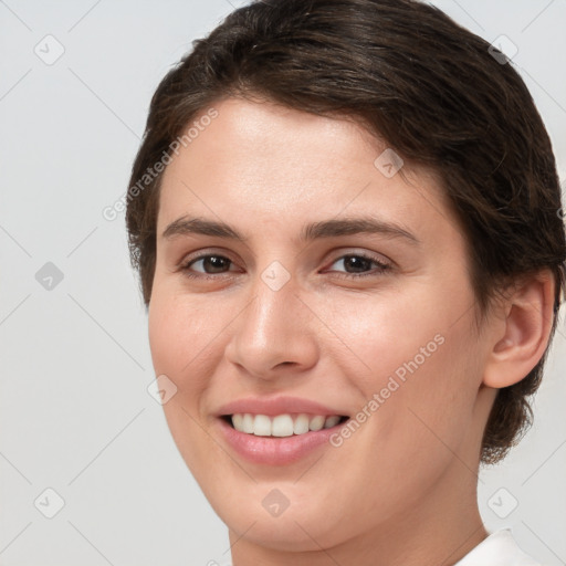 Joyful white young-adult female with short  brown hair and brown eyes