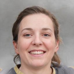 Joyful white adult female with medium  brown hair and blue eyes