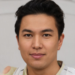 Joyful asian young-adult male with short  brown hair and brown eyes