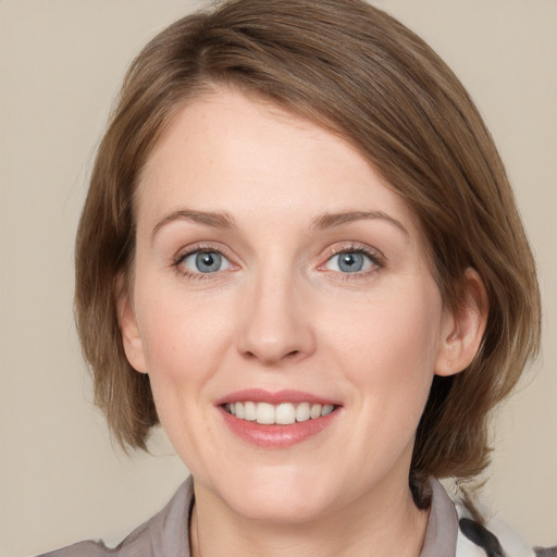 Joyful white young-adult female with medium  brown hair and blue eyes