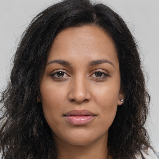 Joyful latino young-adult female with long  brown hair and brown eyes