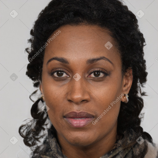 Joyful black young-adult female with long  brown hair and brown eyes