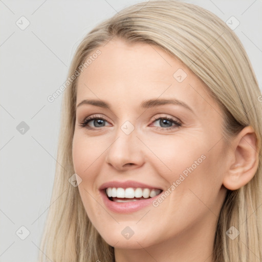 Joyful white young-adult female with long  brown hair and blue eyes