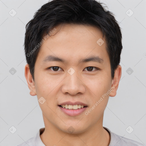 Joyful asian young-adult male with short  brown hair and brown eyes