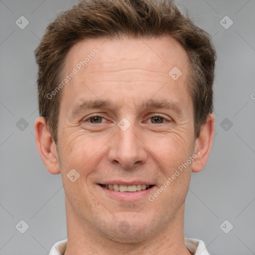 Joyful white adult male with short  brown hair and grey eyes