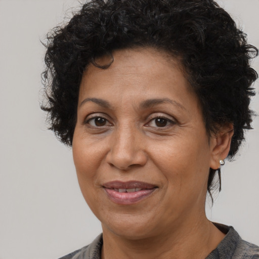 Joyful latino adult female with medium  brown hair and brown eyes