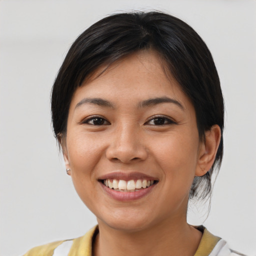 Joyful asian young-adult female with medium  brown hair and brown eyes