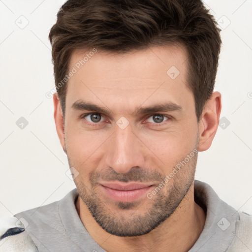 Joyful white young-adult male with short  brown hair and brown eyes