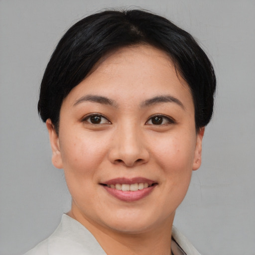 Joyful white young-adult female with short  black hair and brown eyes