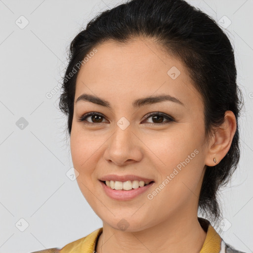 Joyful latino young-adult female with medium  brown hair and brown eyes