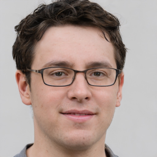 Joyful white adult male with short  brown hair and grey eyes