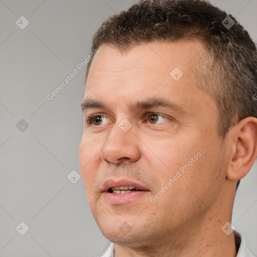 Joyful white adult male with short  brown hair and brown eyes