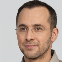 Joyful white adult male with short  brown hair and brown eyes