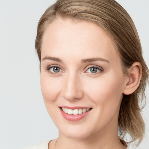 Joyful white young-adult female with medium  brown hair and blue eyes