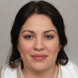 Joyful white adult female with medium  brown hair and brown eyes