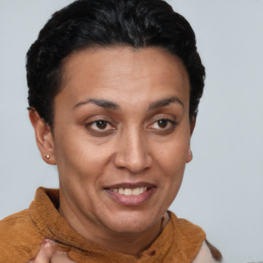 Joyful latino adult female with short  brown hair and brown eyes
