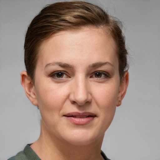 Joyful white young-adult female with short  brown hair and grey eyes