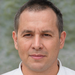 Joyful white adult male with short  brown hair and brown eyes