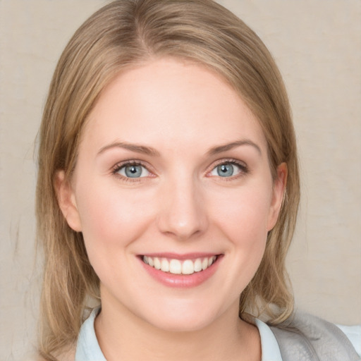 Joyful white young-adult female with medium  brown hair and blue eyes