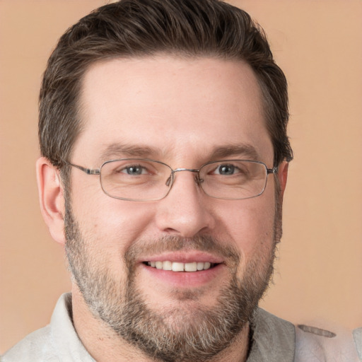 Joyful white adult male with short  brown hair and grey eyes