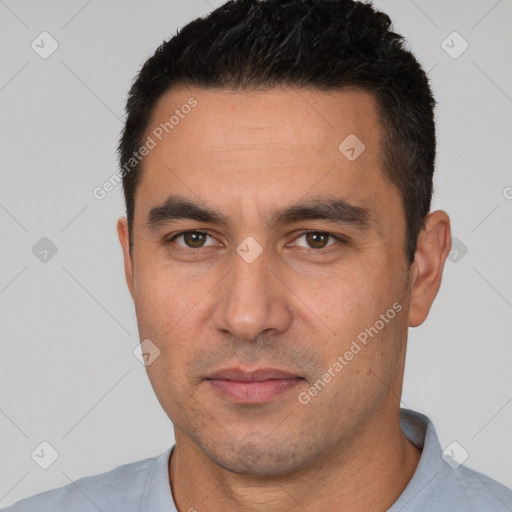 Joyful white young-adult male with short  black hair and brown eyes