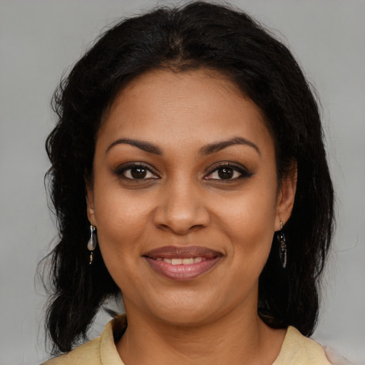 Joyful black young-adult female with medium  brown hair and brown eyes