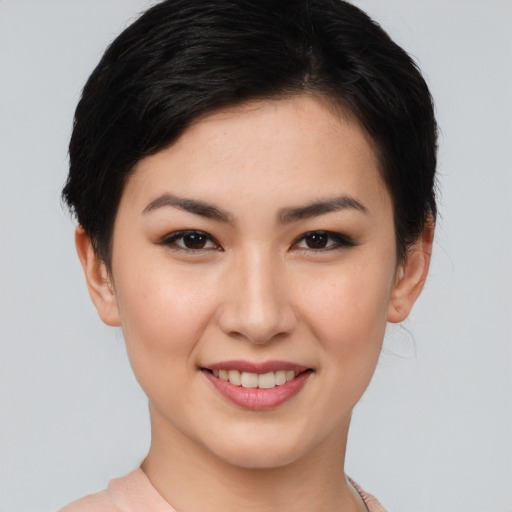 Joyful asian young-adult female with short  brown hair and brown eyes