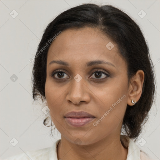 Joyful black adult female with medium  brown hair and brown eyes