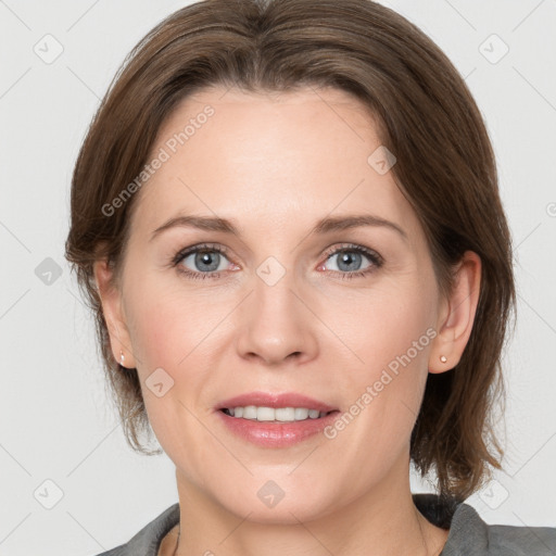 Joyful white adult female with medium  brown hair and grey eyes